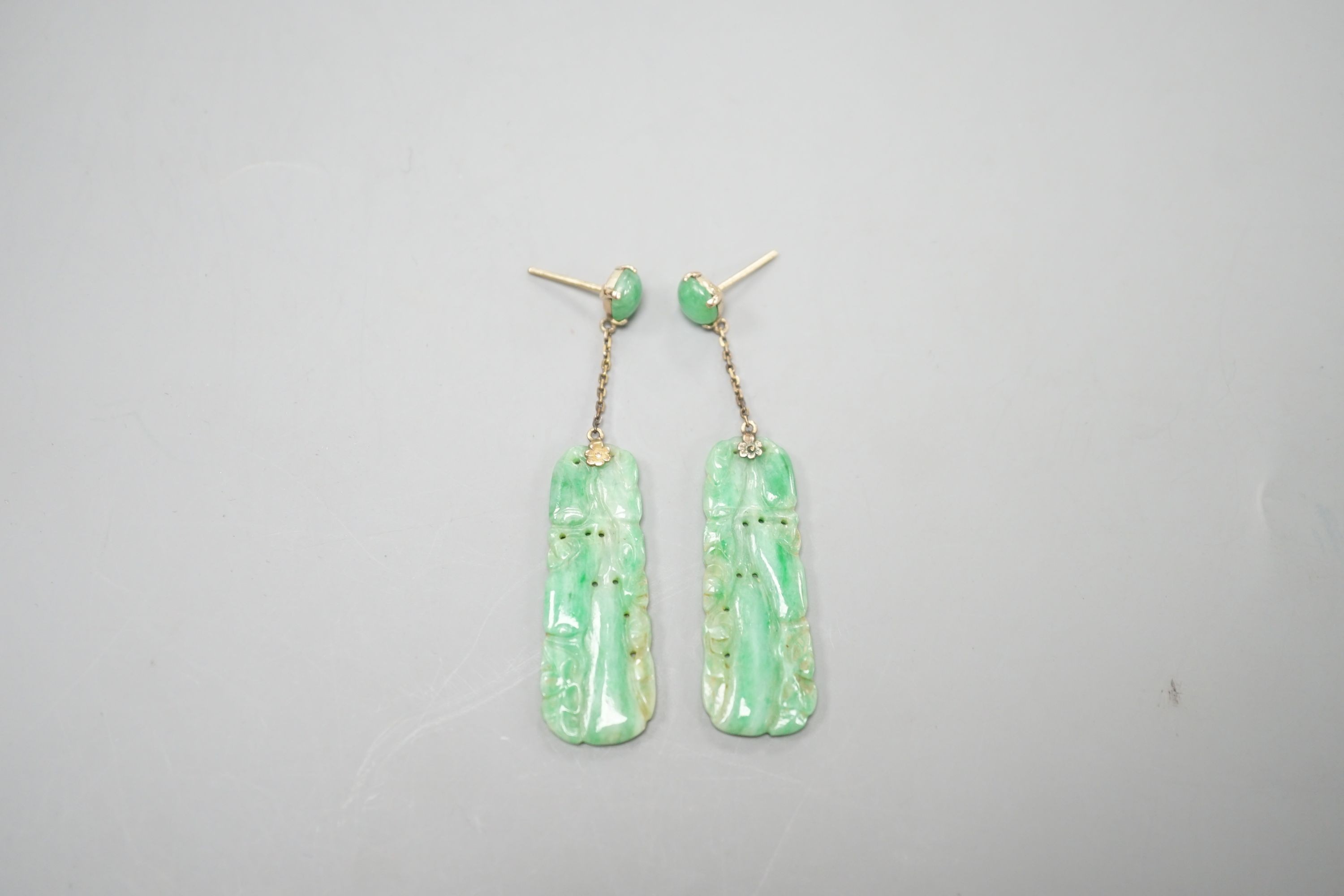 A pair of yellow metal mounted carved jade set drop earrings, overall 5cm, gross weight 7 grams.